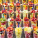 Shelves full of plastic containers of fruit salad for sale